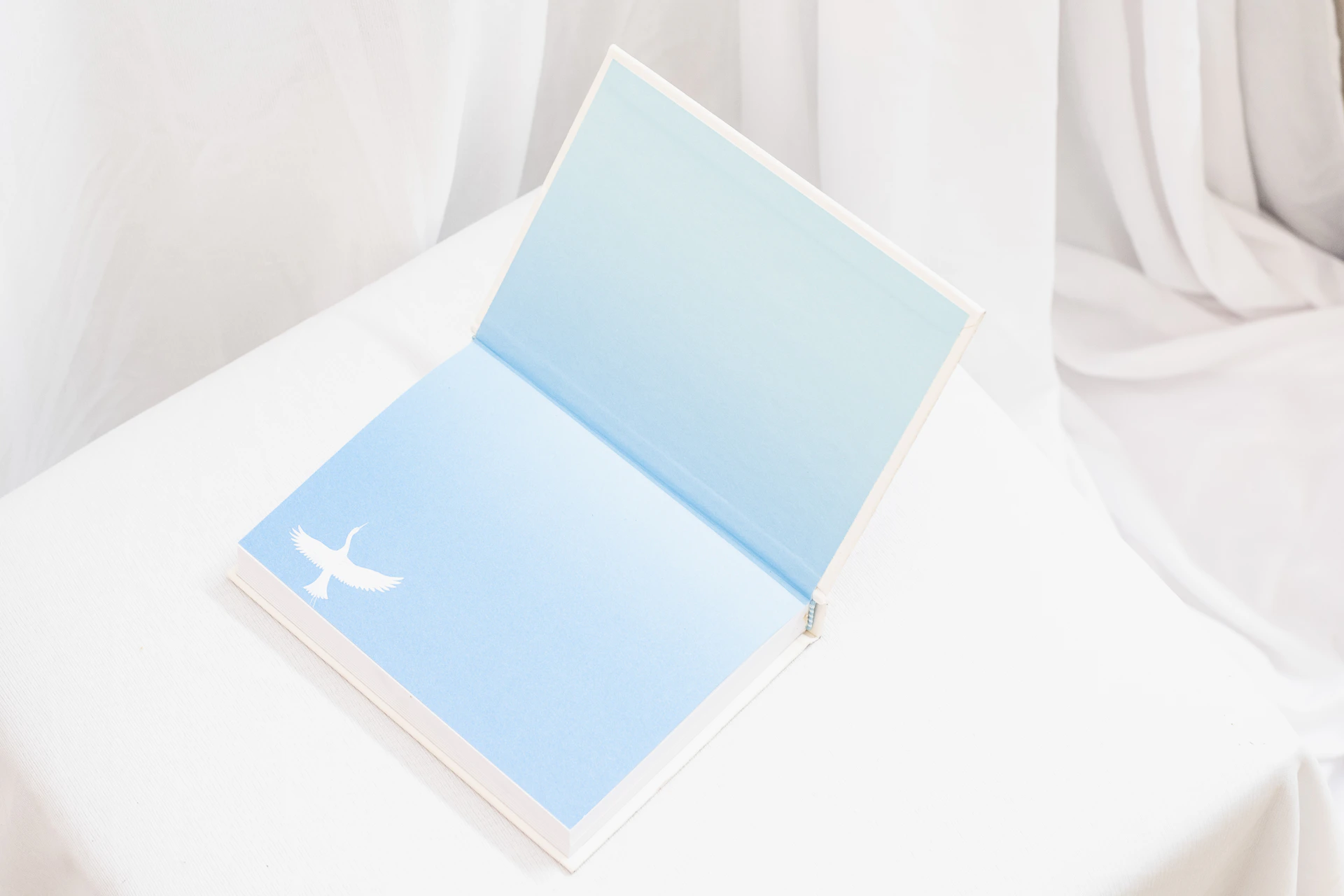 a white table with a blue book on top of it