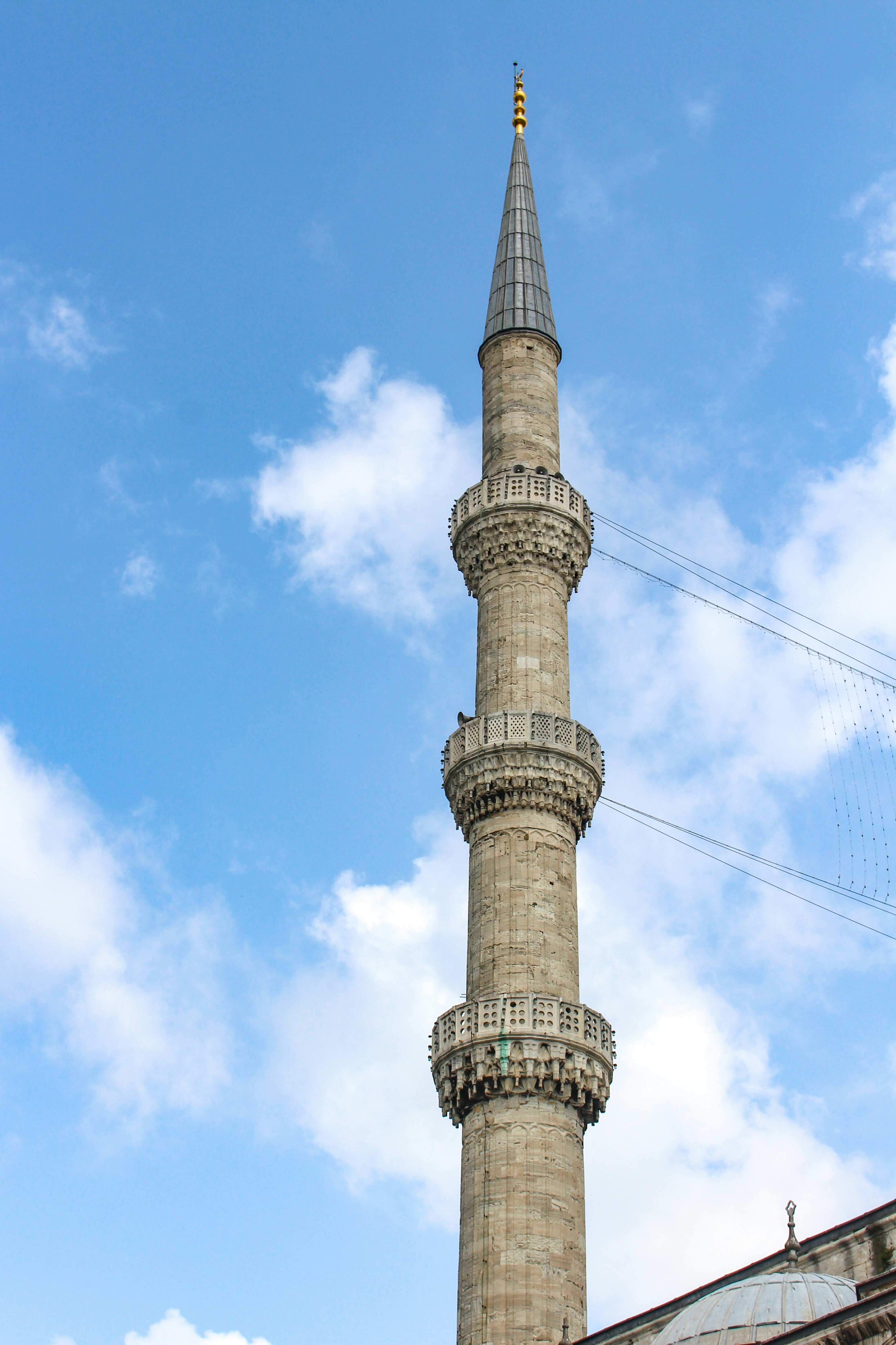 a tall stone tower with a clock on it's side