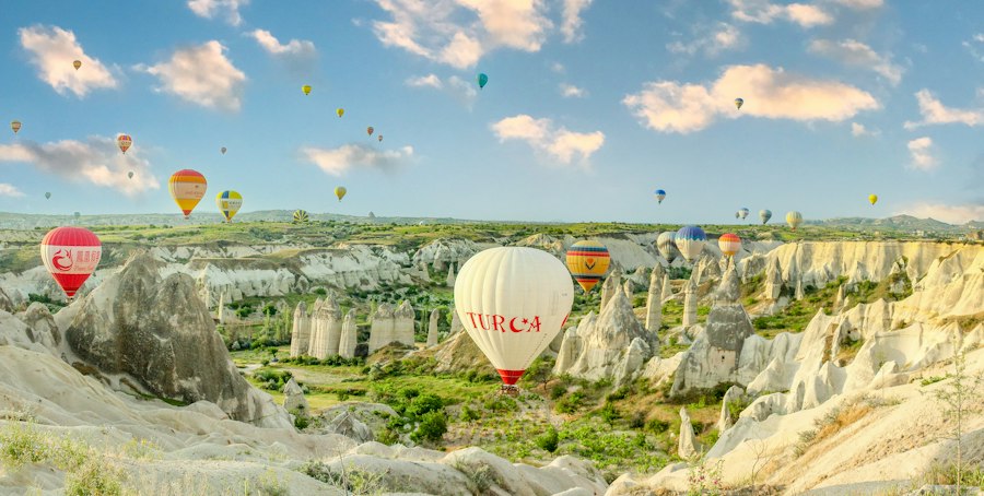 Hot air balloons rising over Cappadocia's fairy chimneys at sunrise