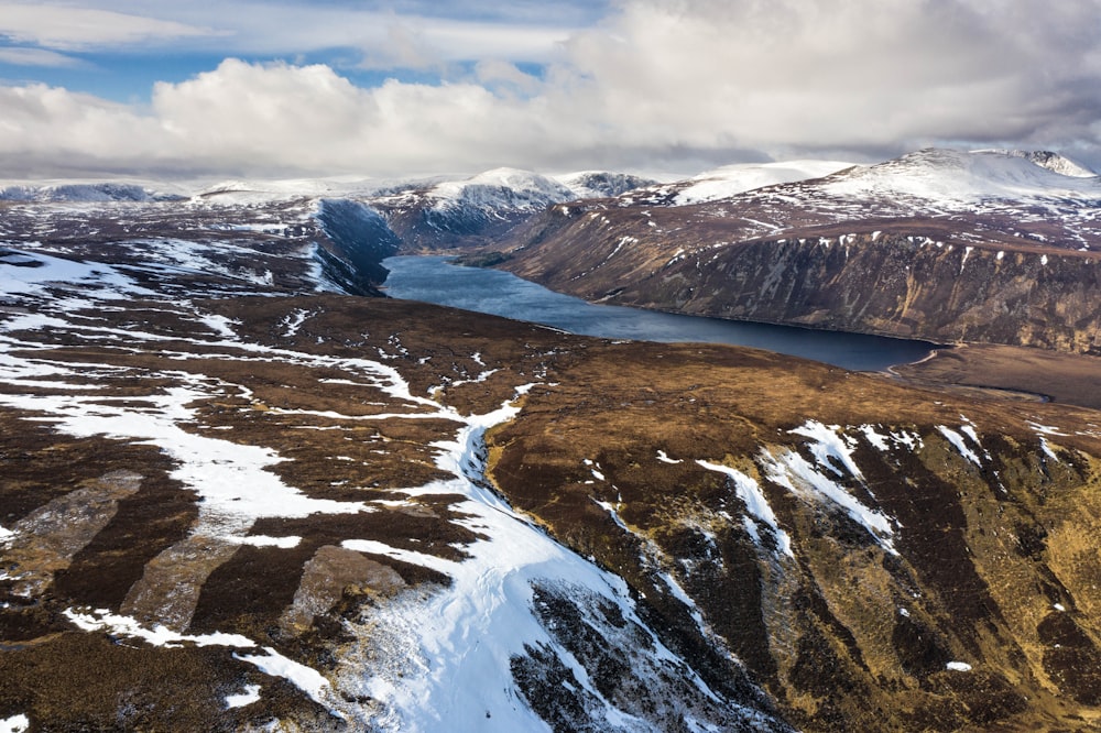 an aerial view of a snow covered mountain range