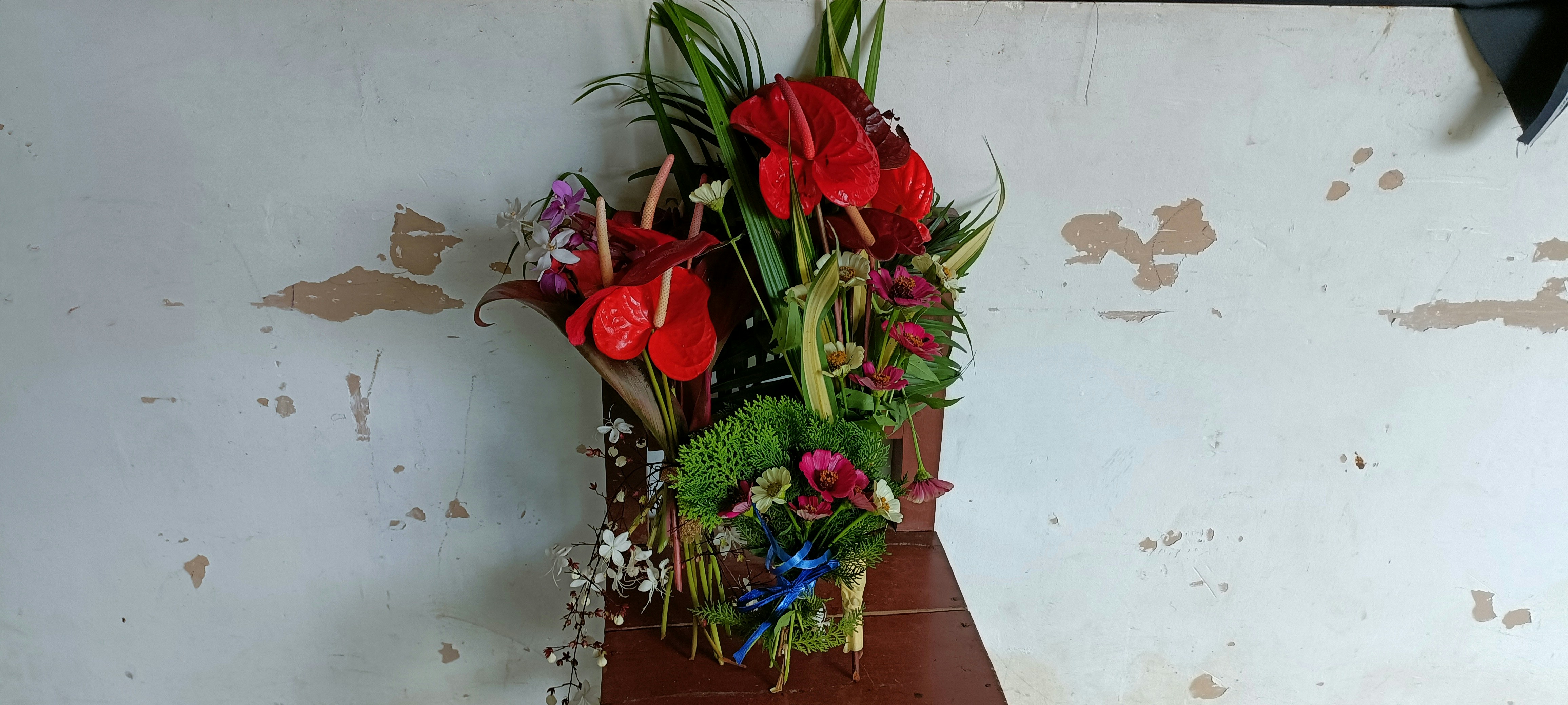 a vase filled with flowers sitting on top of a wooden table