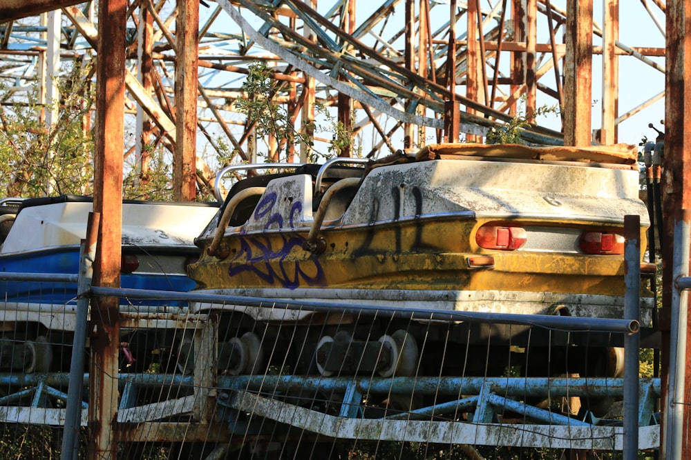 an old car is parked in a junk yard