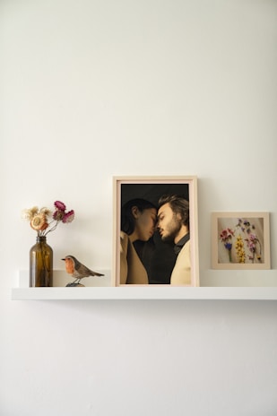 Close-up shot of a stylish photo frame showcasing a family photo on a wooden shelf.