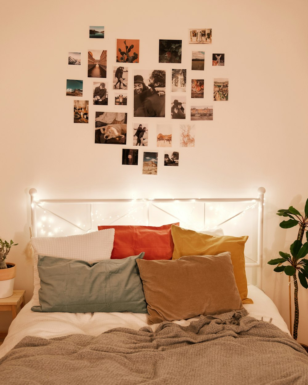 a bed with a bunch of pillows on top of it