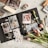 A creatively arranged scrapbook layout featuring various photographs, stickers, and decorative elements on a wooden surface. The open scrapbook displays photos of different subjects including people and flowers, surrounded by vibrant stickers and washi tape. Tulips and small dried flowers add a natural touch to the scene.