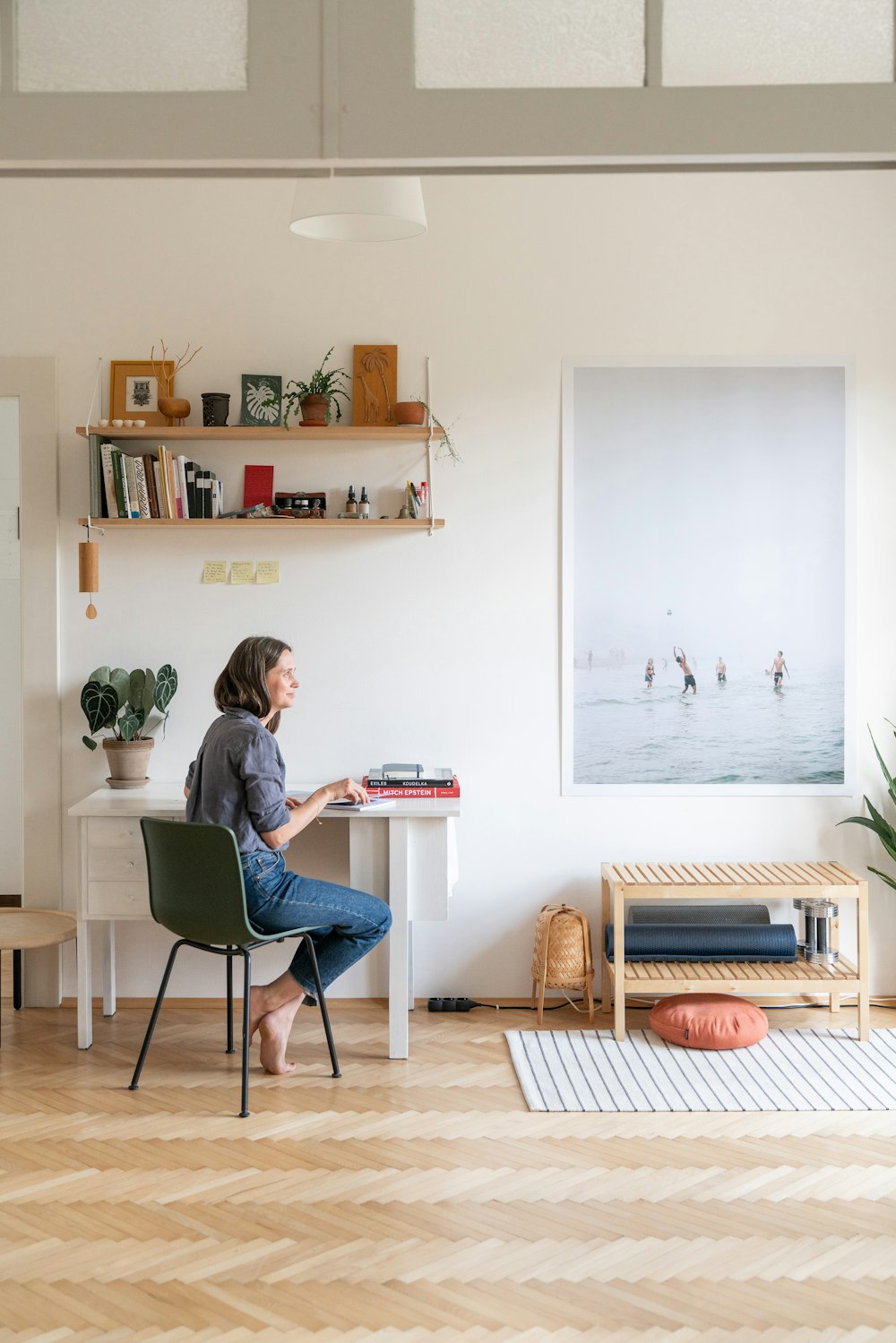 a woman sitting at a desk in a room