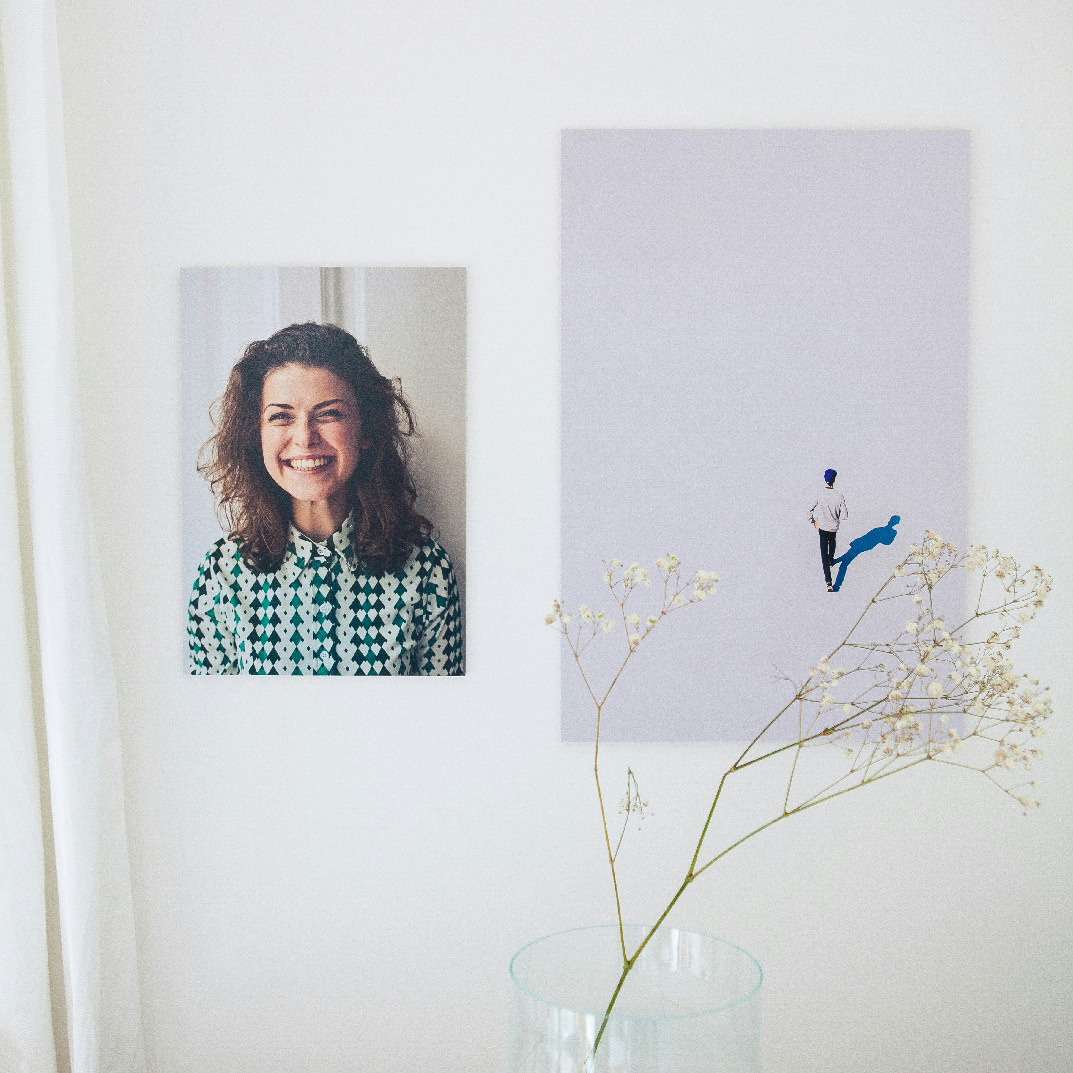 a vase filled with flowers next to a picture of a woman