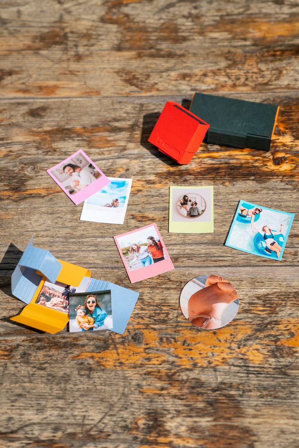 a wooden table topped with pictures and magnets