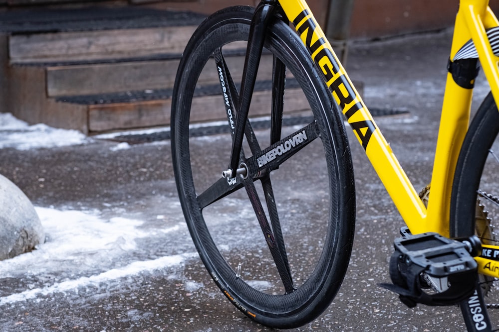 a close up of a yellow bike on a street