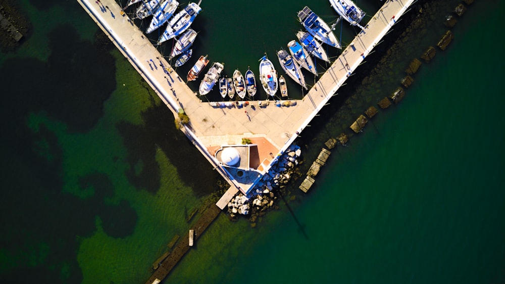 an aerial view of a dock with several boats