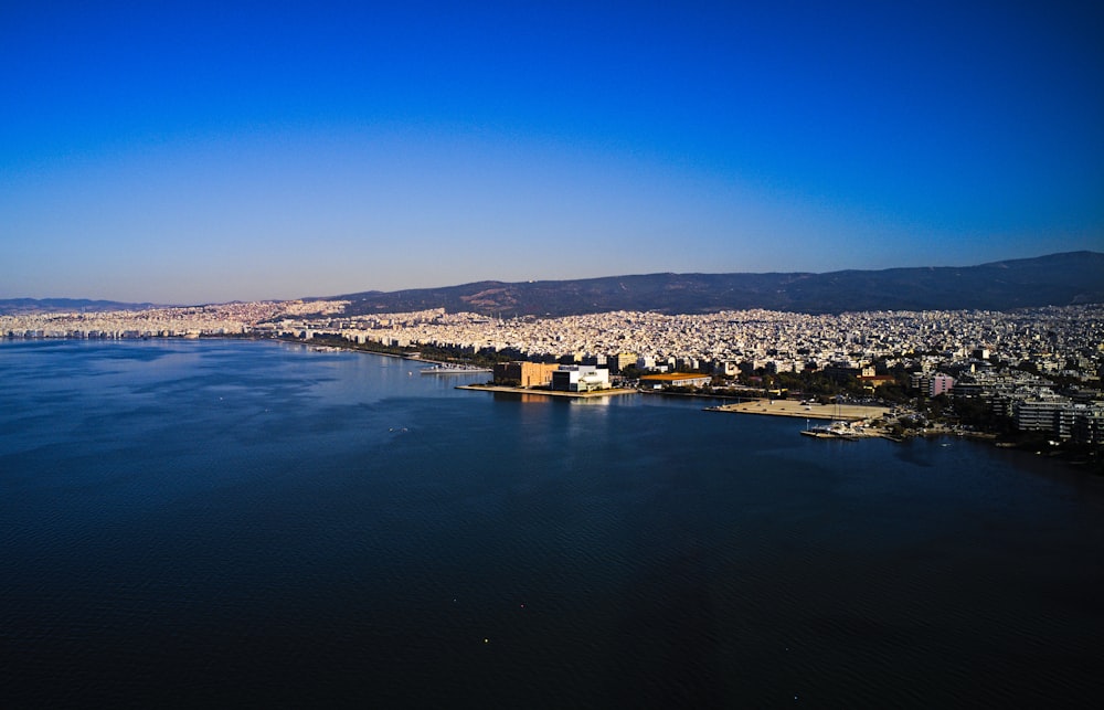 a large body of water with a city in the background