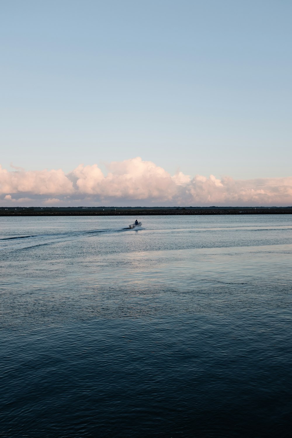 a person on a boat in the middle of the ocean