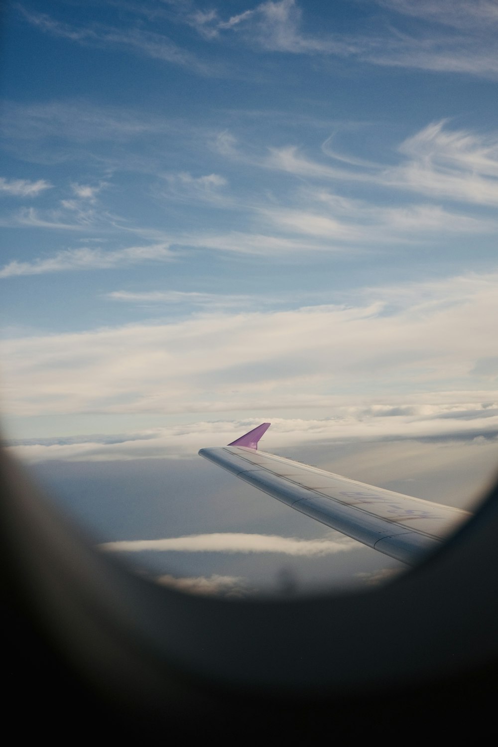 a view of the wing of an airplane in the sky