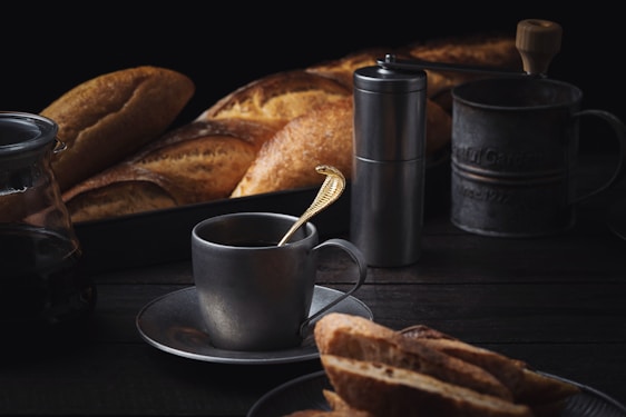 Cozy deli market corner with fresh bread, charcuterie, and a steaming cup of coffee on a wooden table.