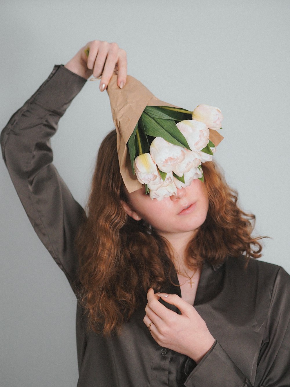 a woman wearing a paper hat with flowers on it