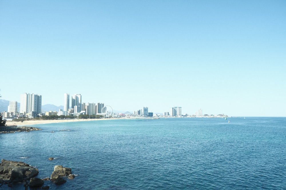 a view of a beach with a city in the background