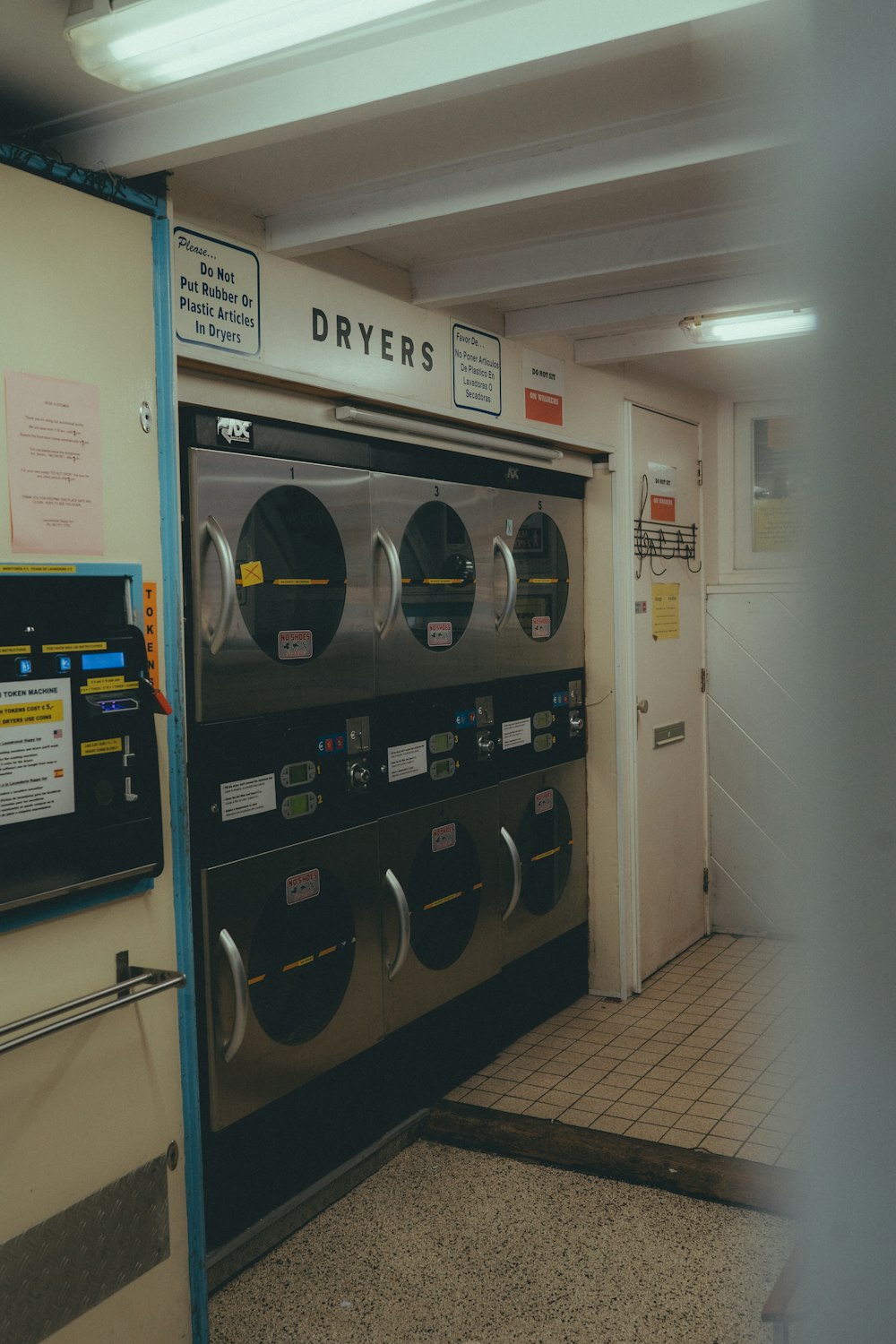 a row of dryers in a public restroom