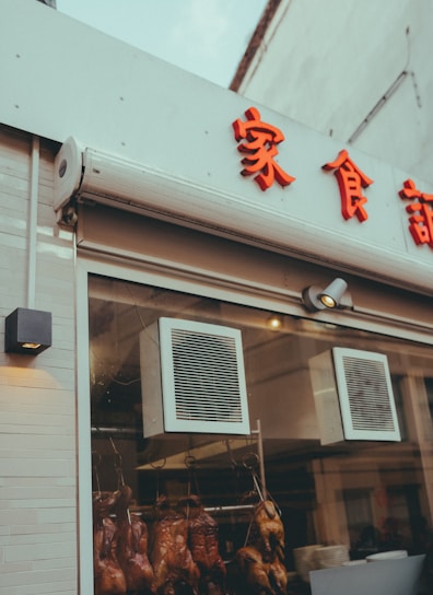 A cozy small restaurant interior showcasing rustic wood tables and a steaming dish of carefully prepared duck.