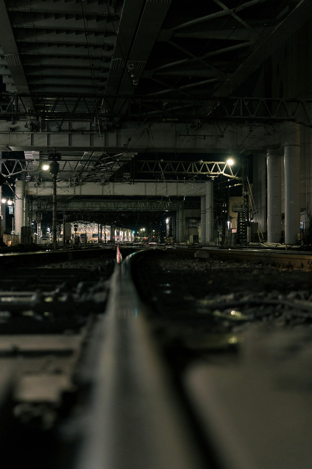 a train traveling under a bridge at night