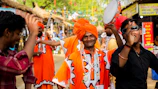 Festive dancers in vibrant traditional attire celebrating a lively Punjab festival outdoors.