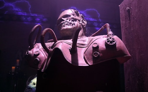 A dark, eerie setting featuring a menacing skeletal figure encased in a complex mechanical harness. The atmosphere is intensified by the presence of purple lightning in the background, and the scene is dimly lit, creating a sense of mystery and foreboding.