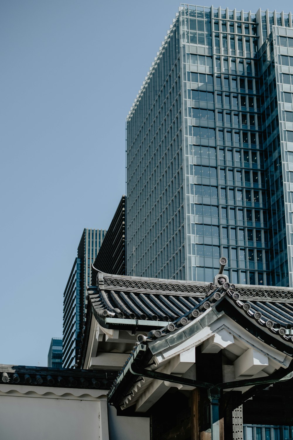 a tall building next to a very tall building