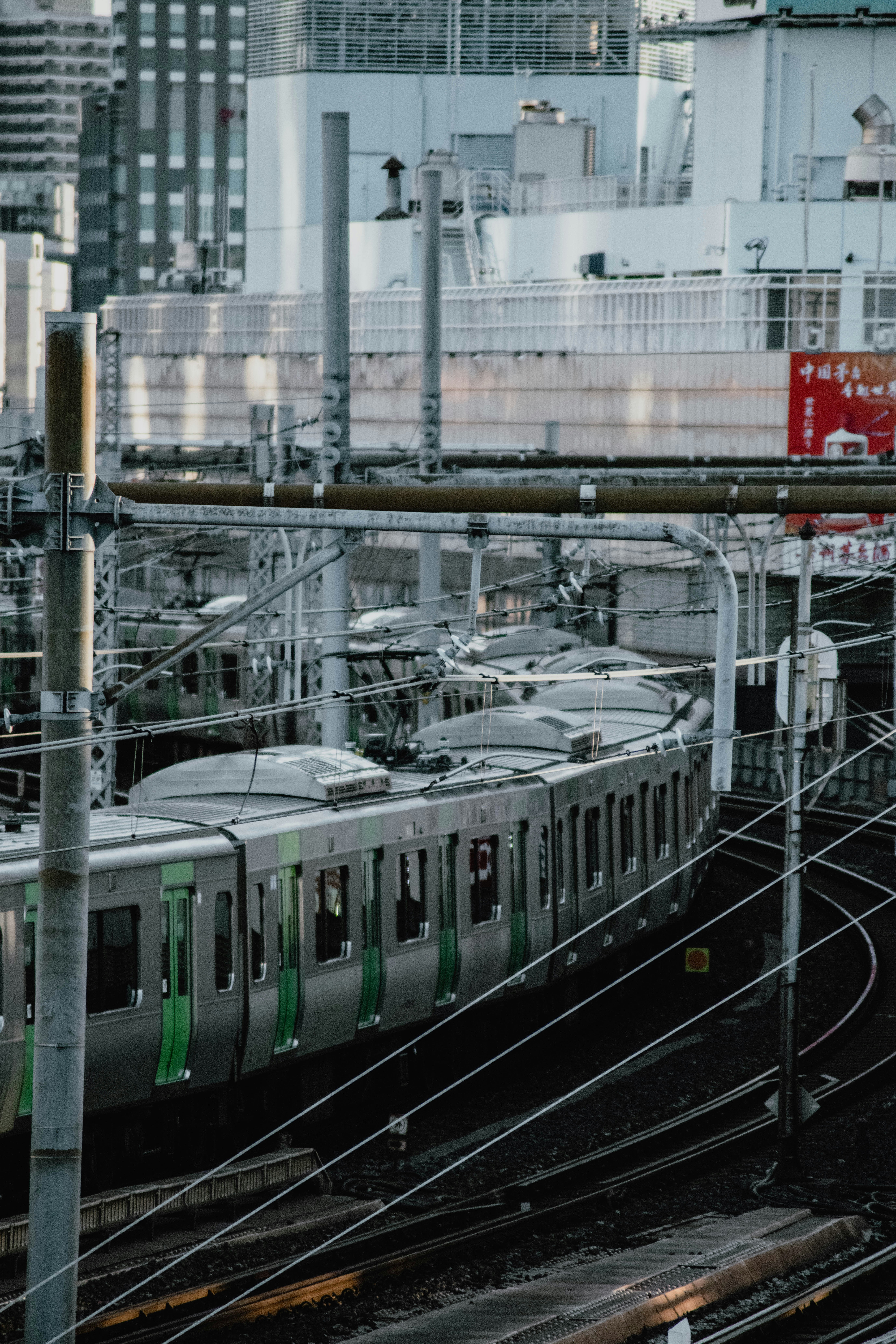 a train traveling through a train station next to tall buildings