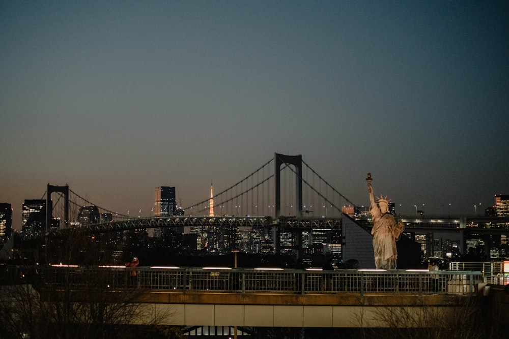 the statue of liberty stands in front of the city skyline