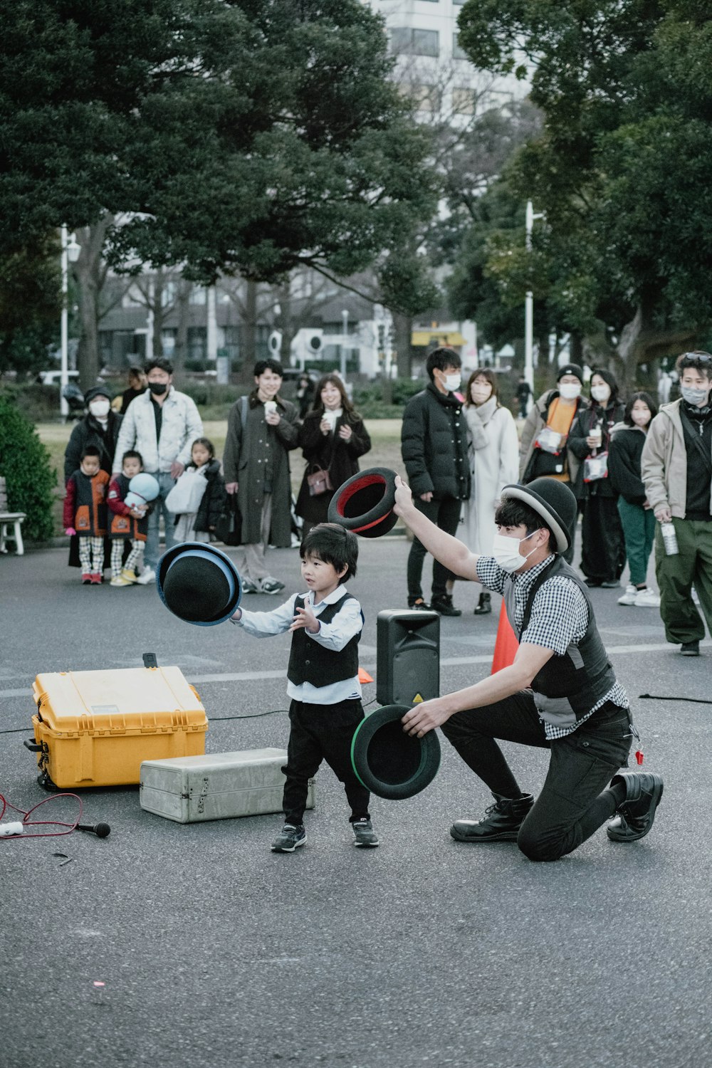 a man kneeling down next to a boy holding a frisbee