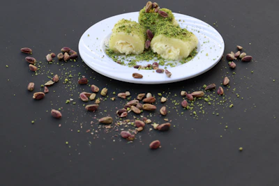 Rows of rich pistachio brownies with a smooth, creamy topping and sprinkled pistachio crumbs.