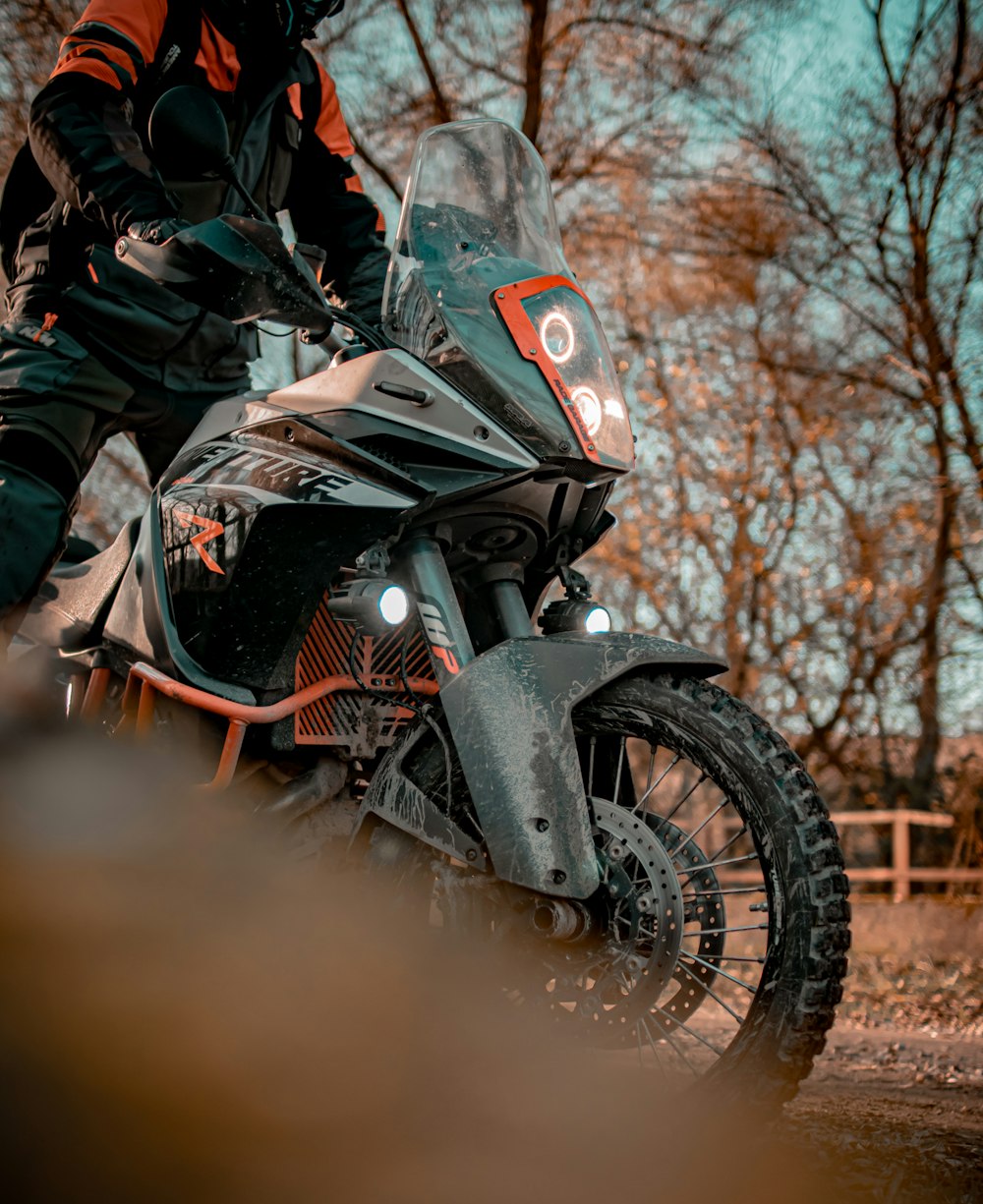 a person riding a motorcycle on a dirt road