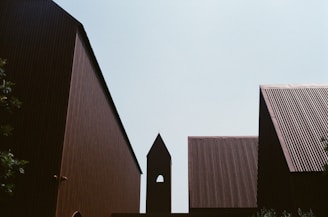 Minimalist urban scene in monochrome, showing sharp architectural lines against a clear sky.