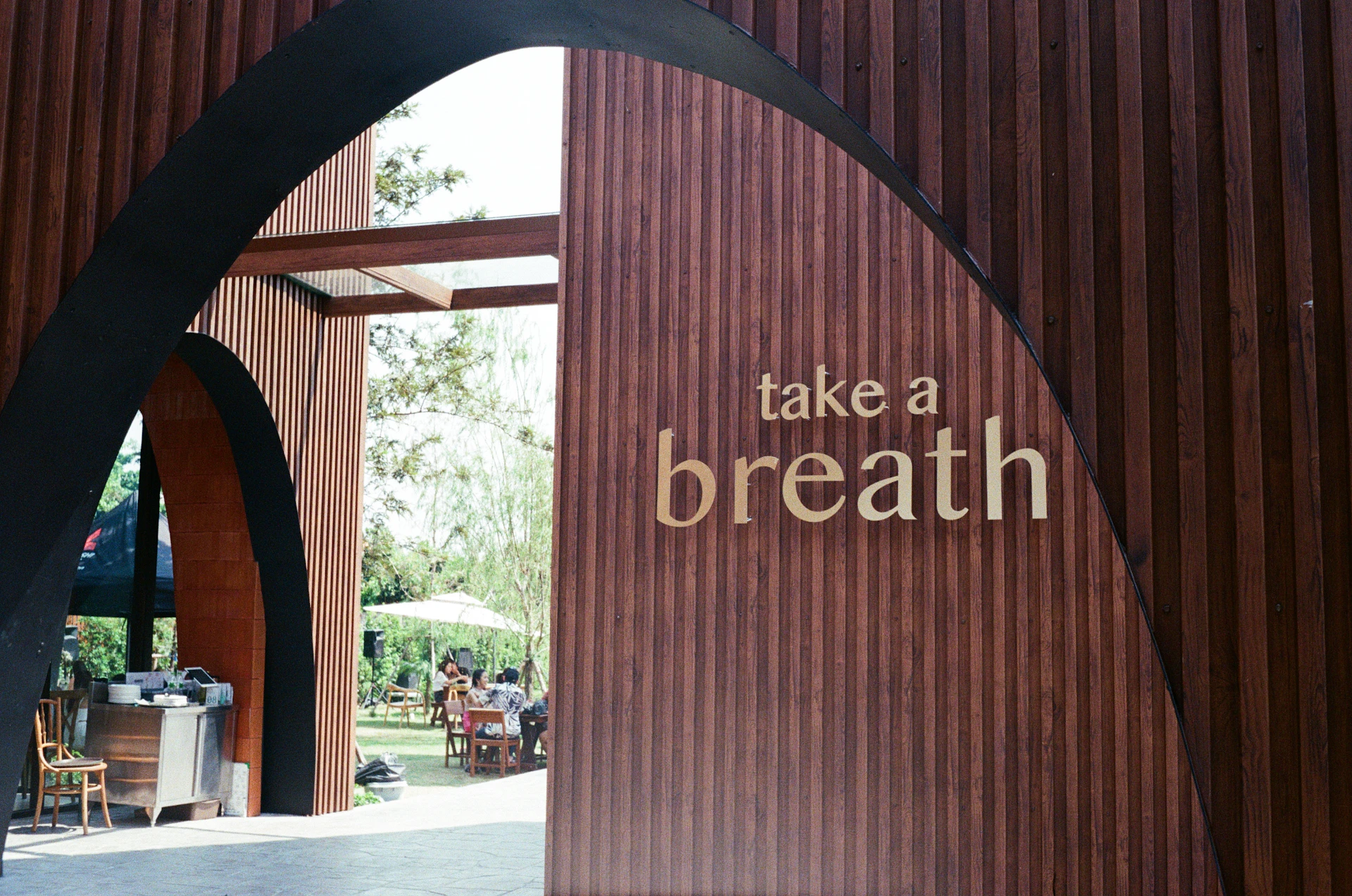 a sign that says take a breath on the side of a building