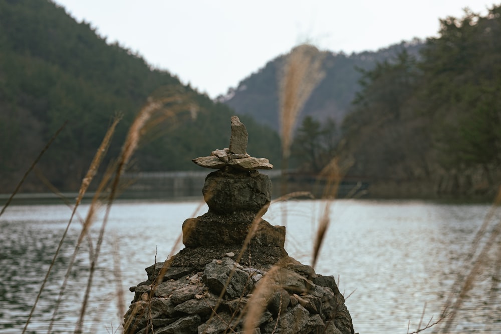 a rock formation in front of a body of water
