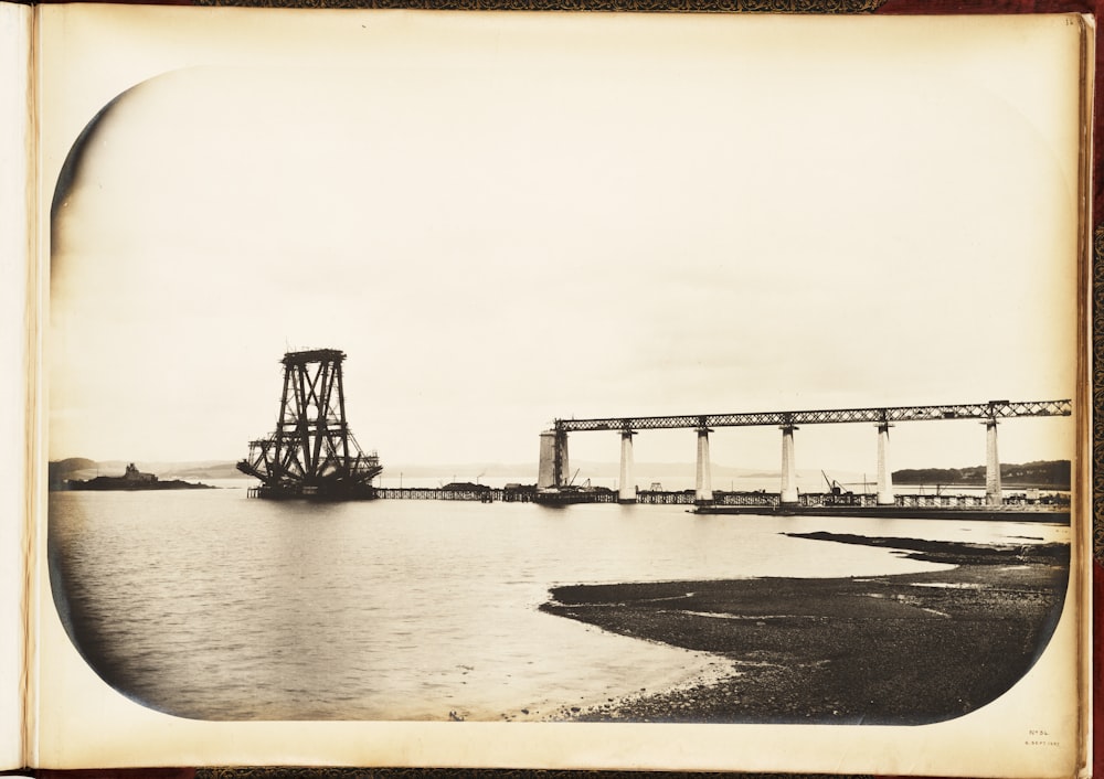 an old photo of a bridge over a body of water