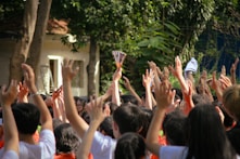 a group of people holding up their hands in the air
