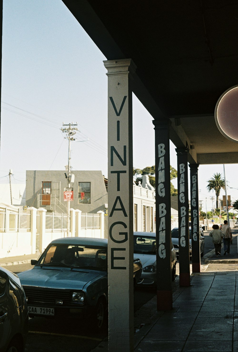 a sign that says vintage on it next to cars