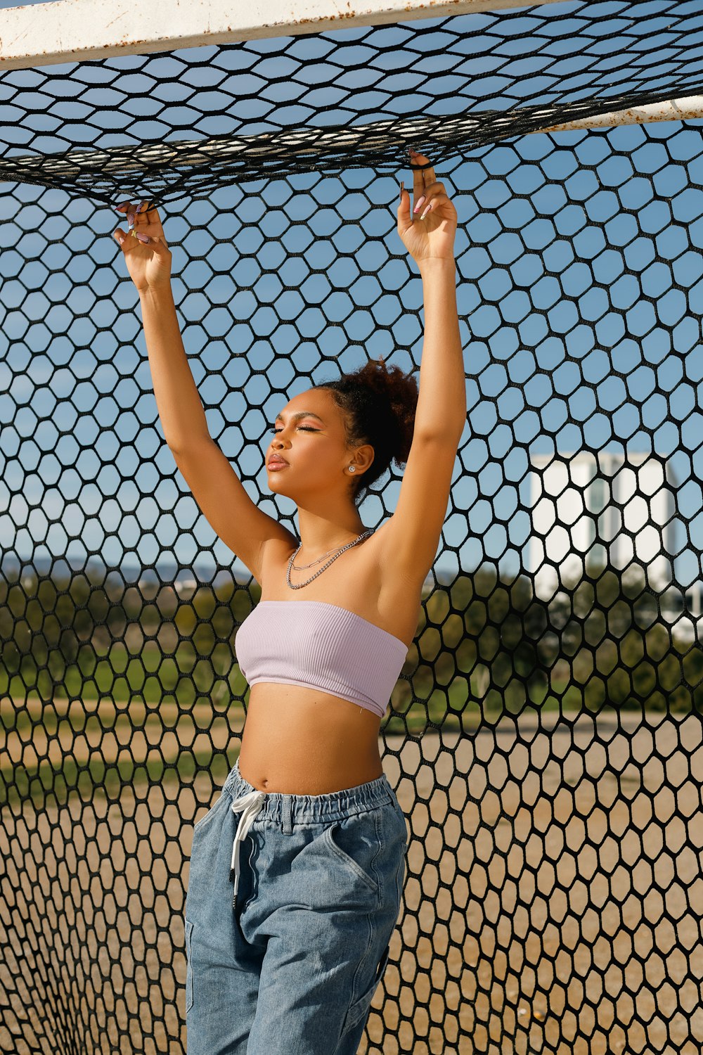 a woman in a sports bra top holding a tennis racket