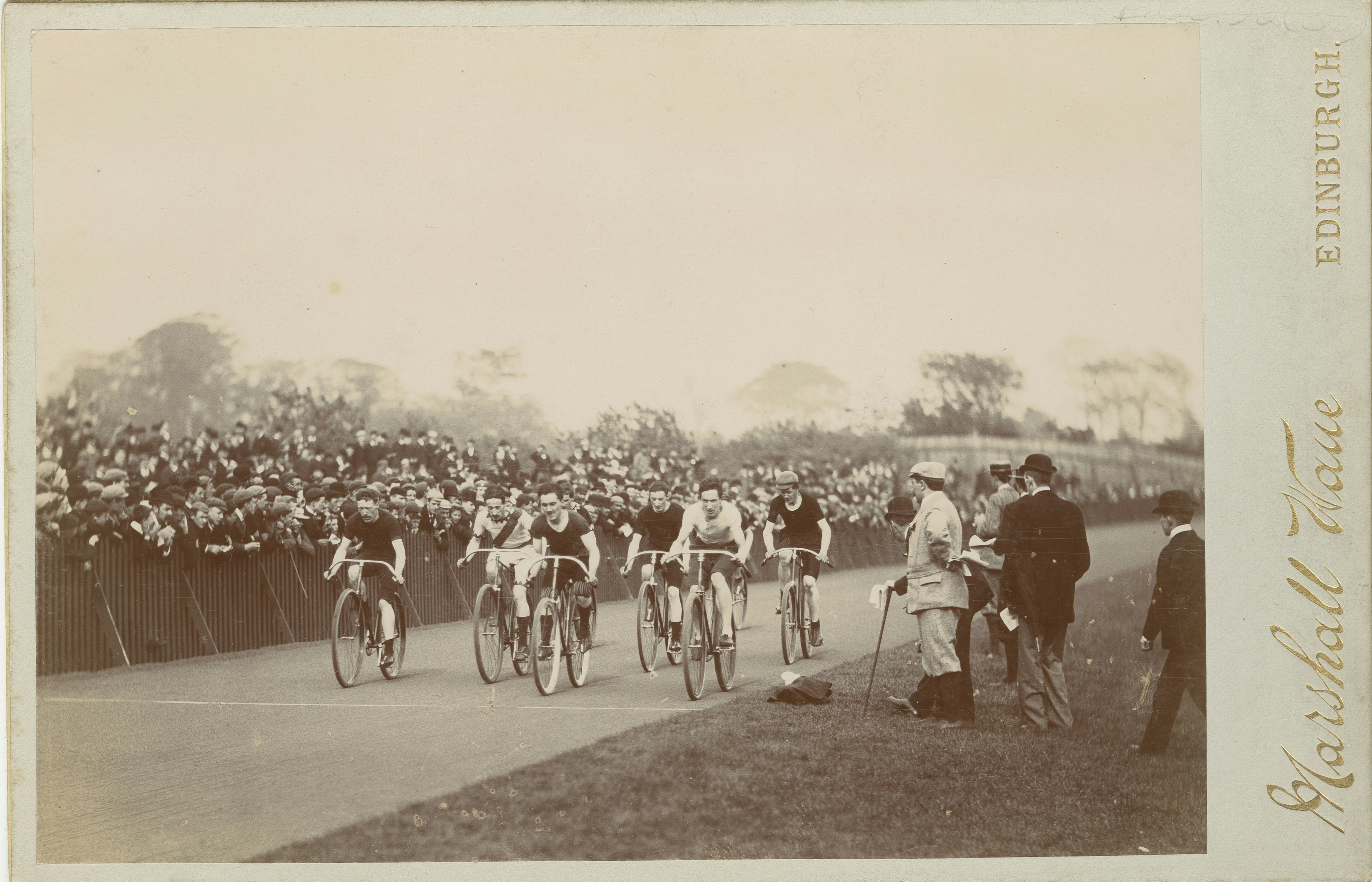 a group of people riding bikes down a road