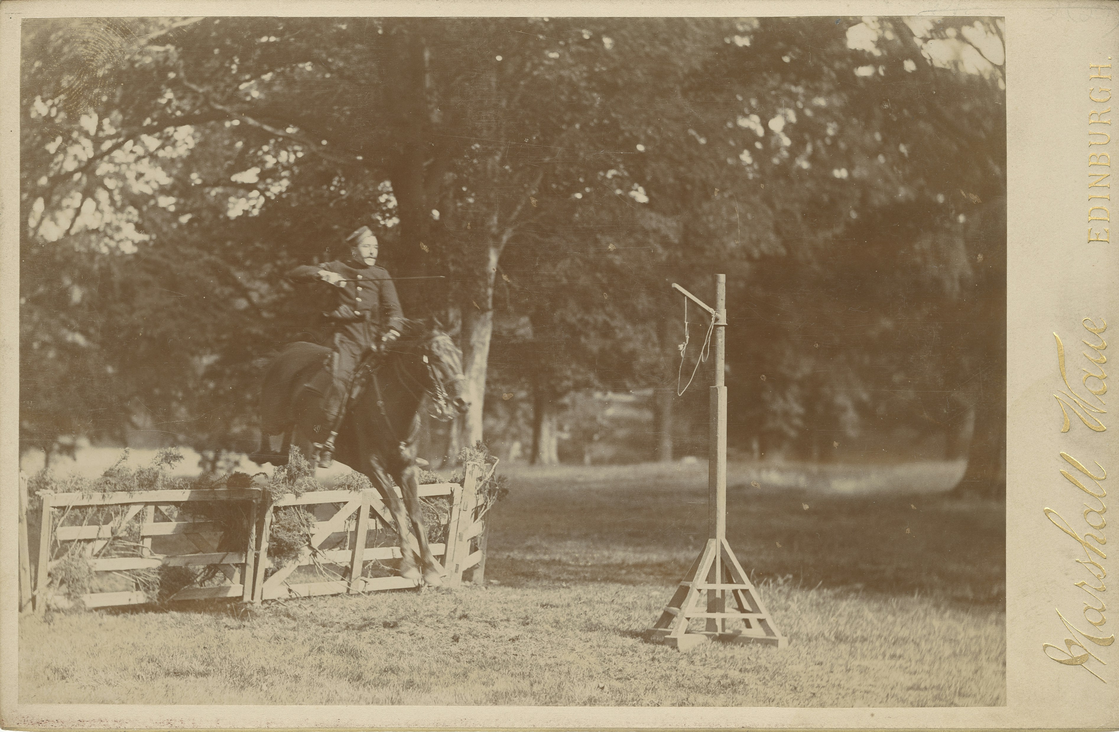 an old photo of a person riding a horse