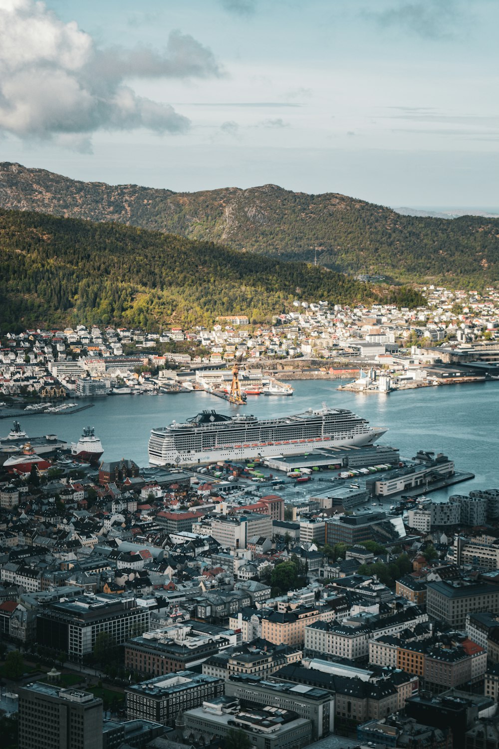 a cruise ship docked in a harbor next to a city