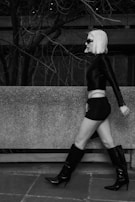 A model walking confidently in a modern urban environment.