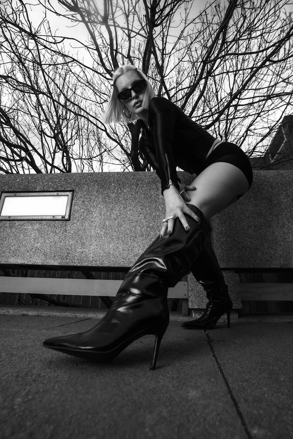 a woman in high heels leaning against a wall