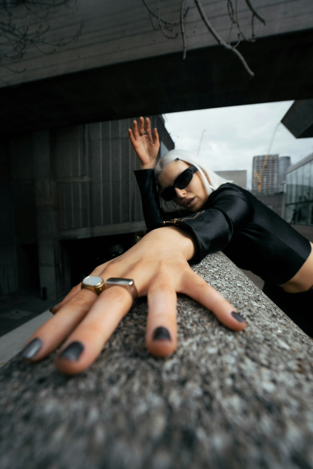 a woman laying on top of a stone wall