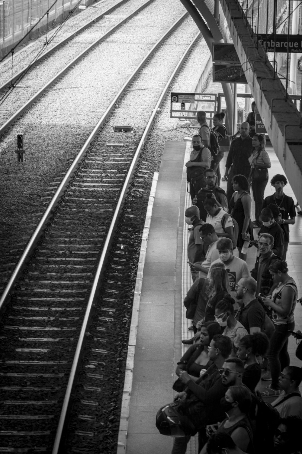 a group of people waiting at a train station
