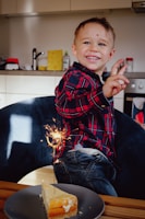 Children proudly presenting their culinary creations with smiles.