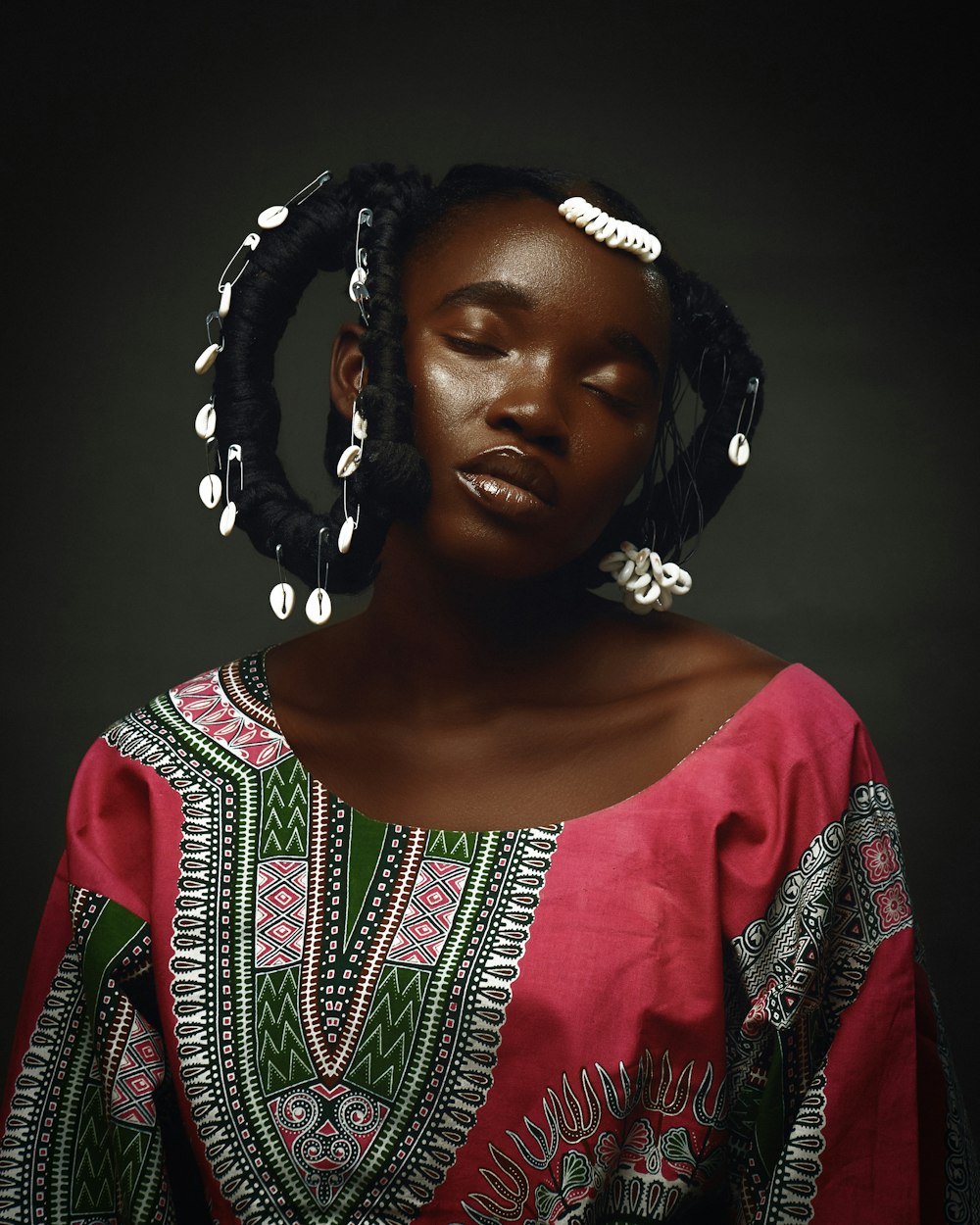 a woman in a red dress with a braid in her hair