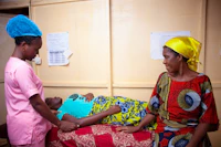 A mother and newborn in a hospital ward