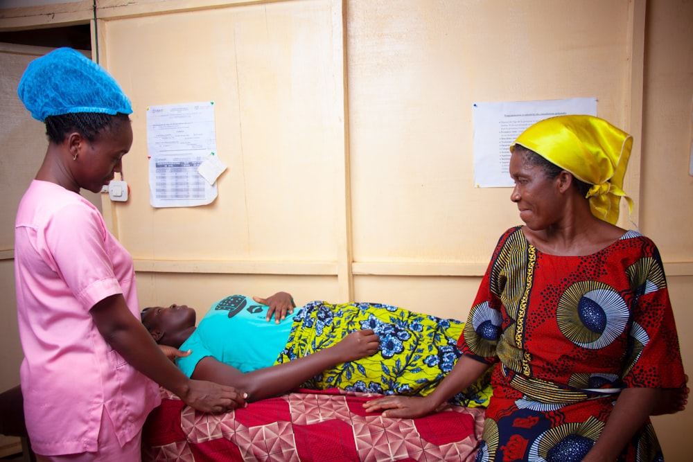 a woman holding a baby in a hospital bed