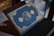 A happy customer unboxing a beautifully wrapped Islamic book at home.